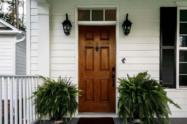 Seahorse Shaped Lighted Doorbell Button on Front Door of House