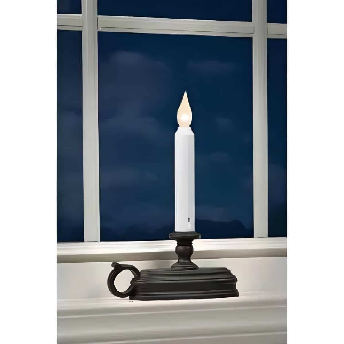 FPC1525ABZ Single Tier LED Window Candle W/ White Flame in Aged Bronze Base in a Window at Night